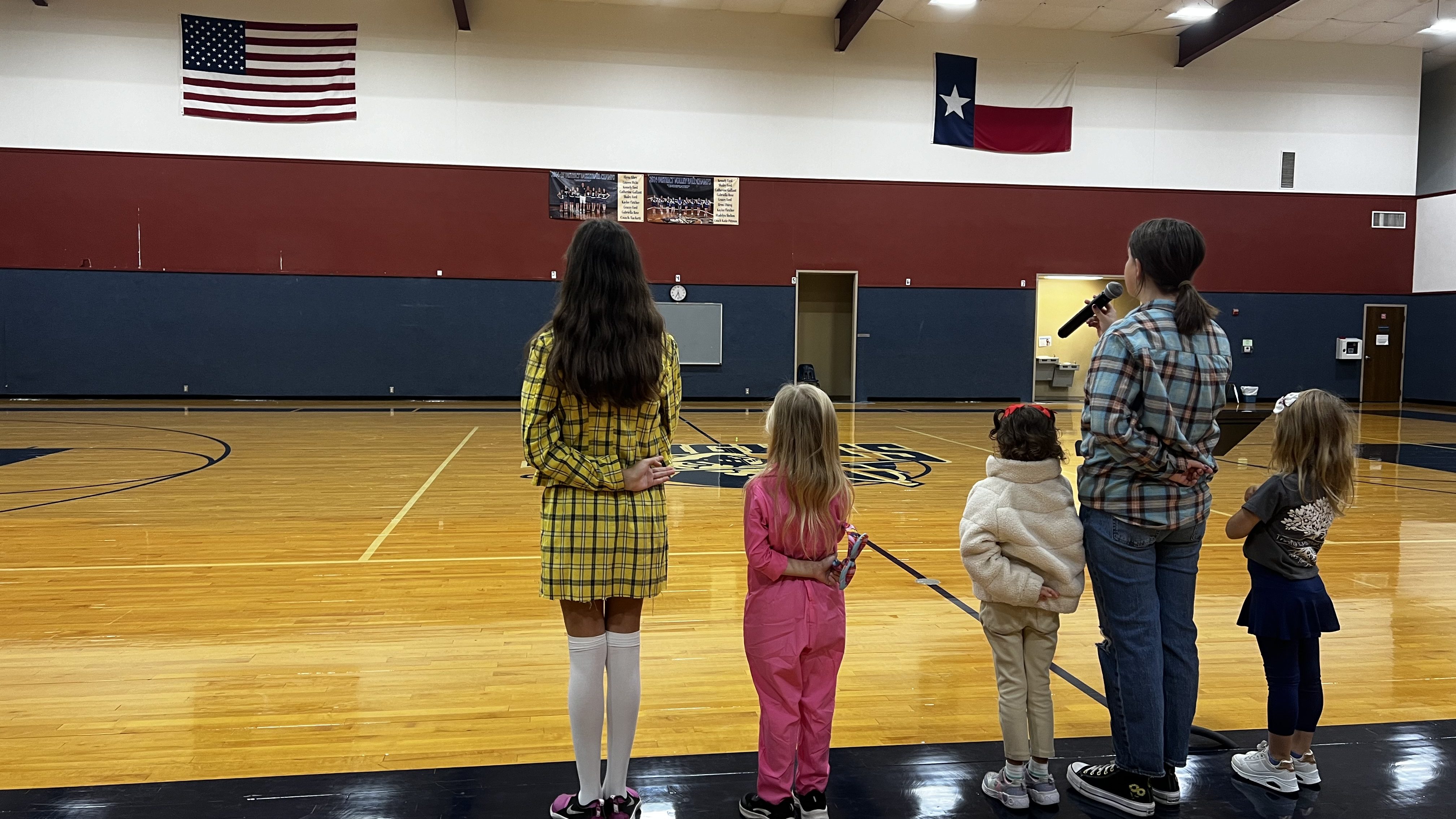 Student pledging to the American and Texas flags